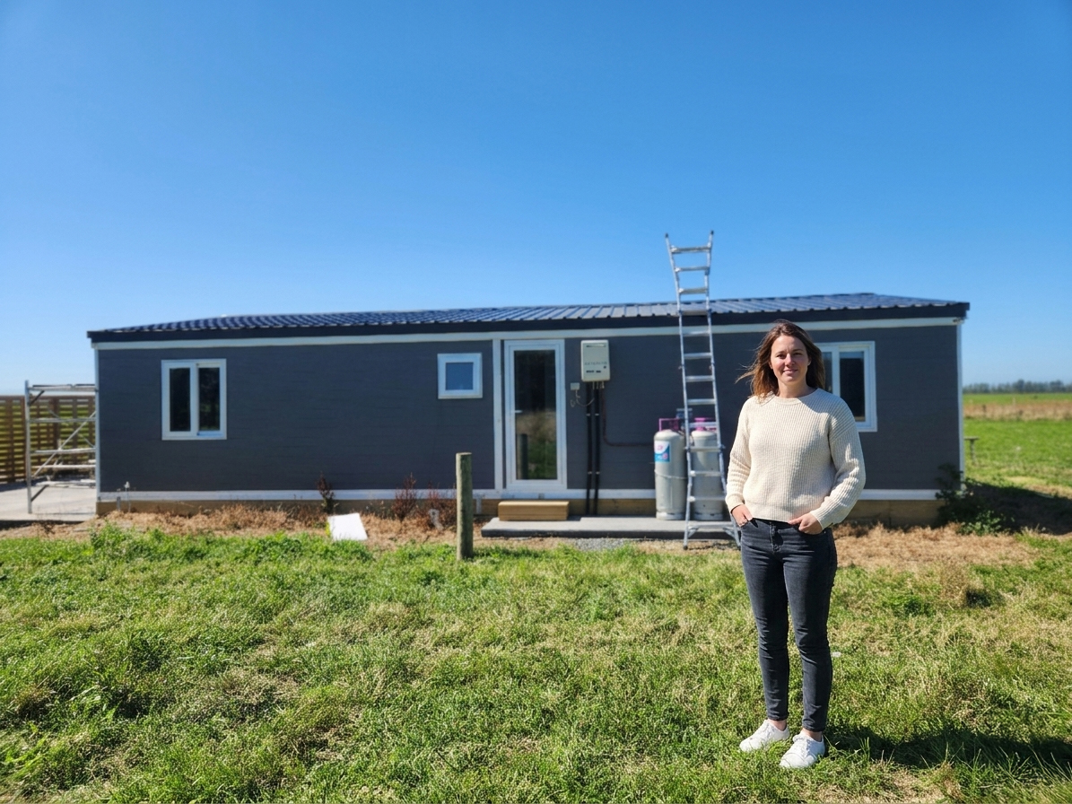 Customer standing in front of their new Expanders® home